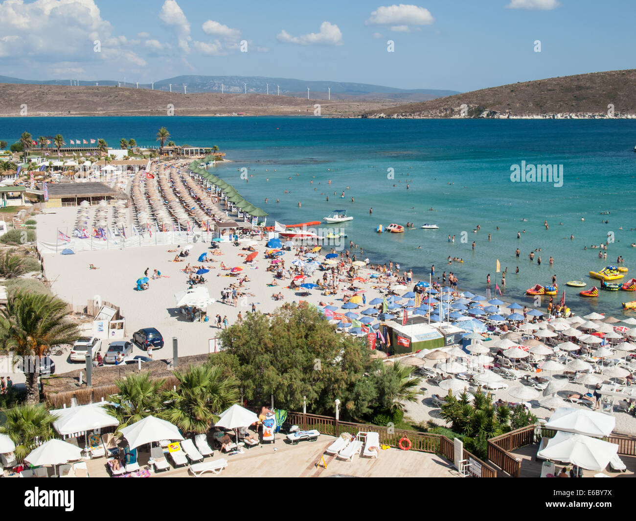 Cesme, Turkey,  August 2nd, 2014: Tourist beach on the Cesme peninsula in high season. The area in the Turkish Aegean region  ha Stock Photo