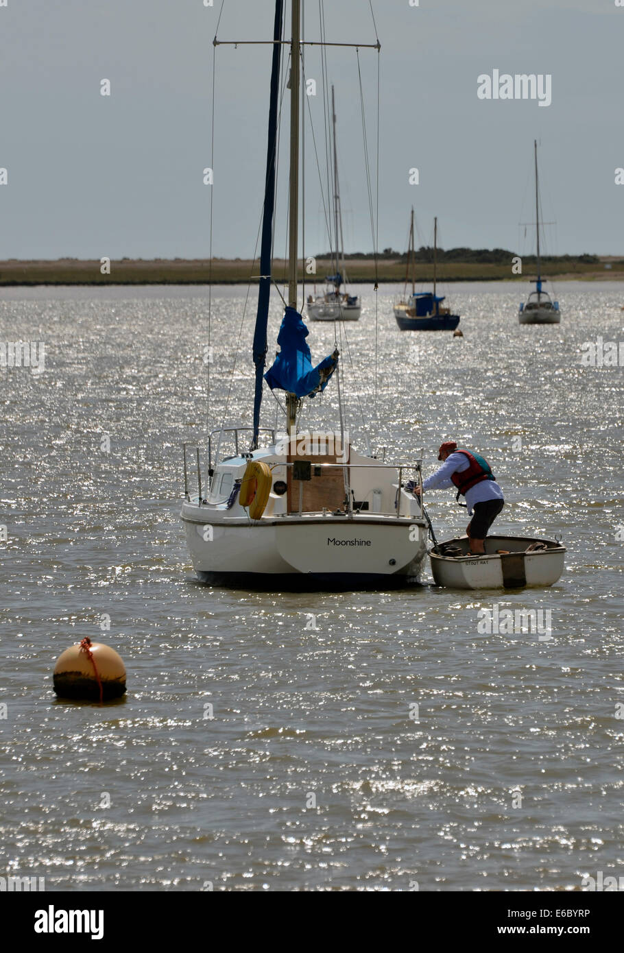older man boarding sailboat at orford suffolk Stock Photo