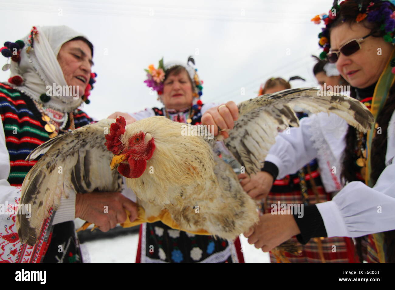 Elderly Bulgarian women dressed in traditional costumes dance and