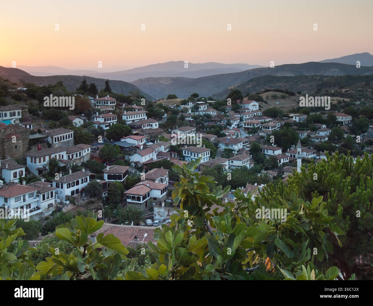 view over  the turkish village of sirince in izmir province at sunset with fig tree in foreground Stock Photo
