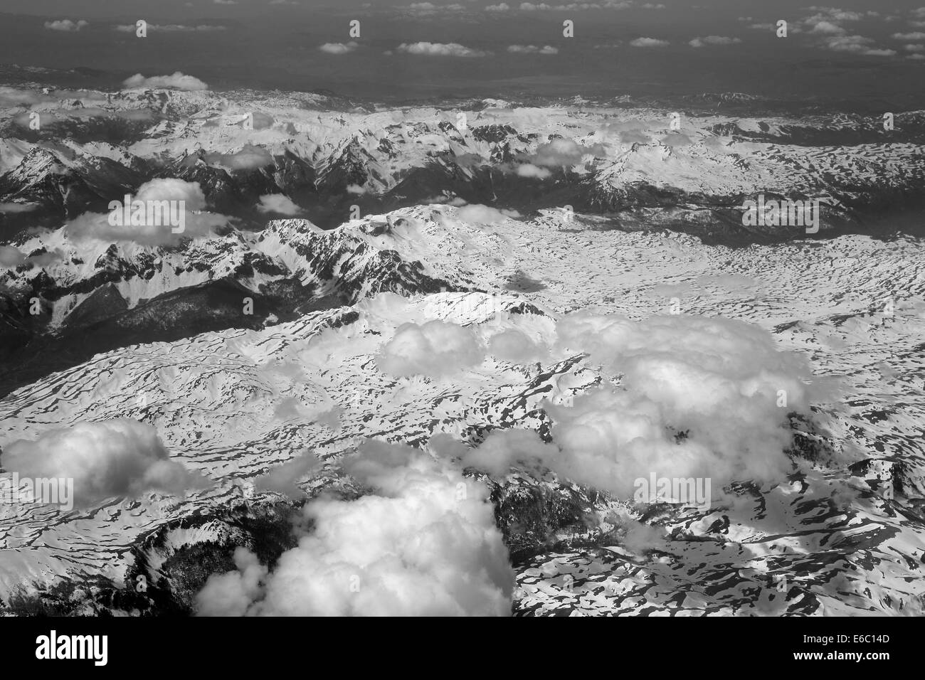 The view from the airplane window at the beautiful weather with clouds and mountains Stock Photo