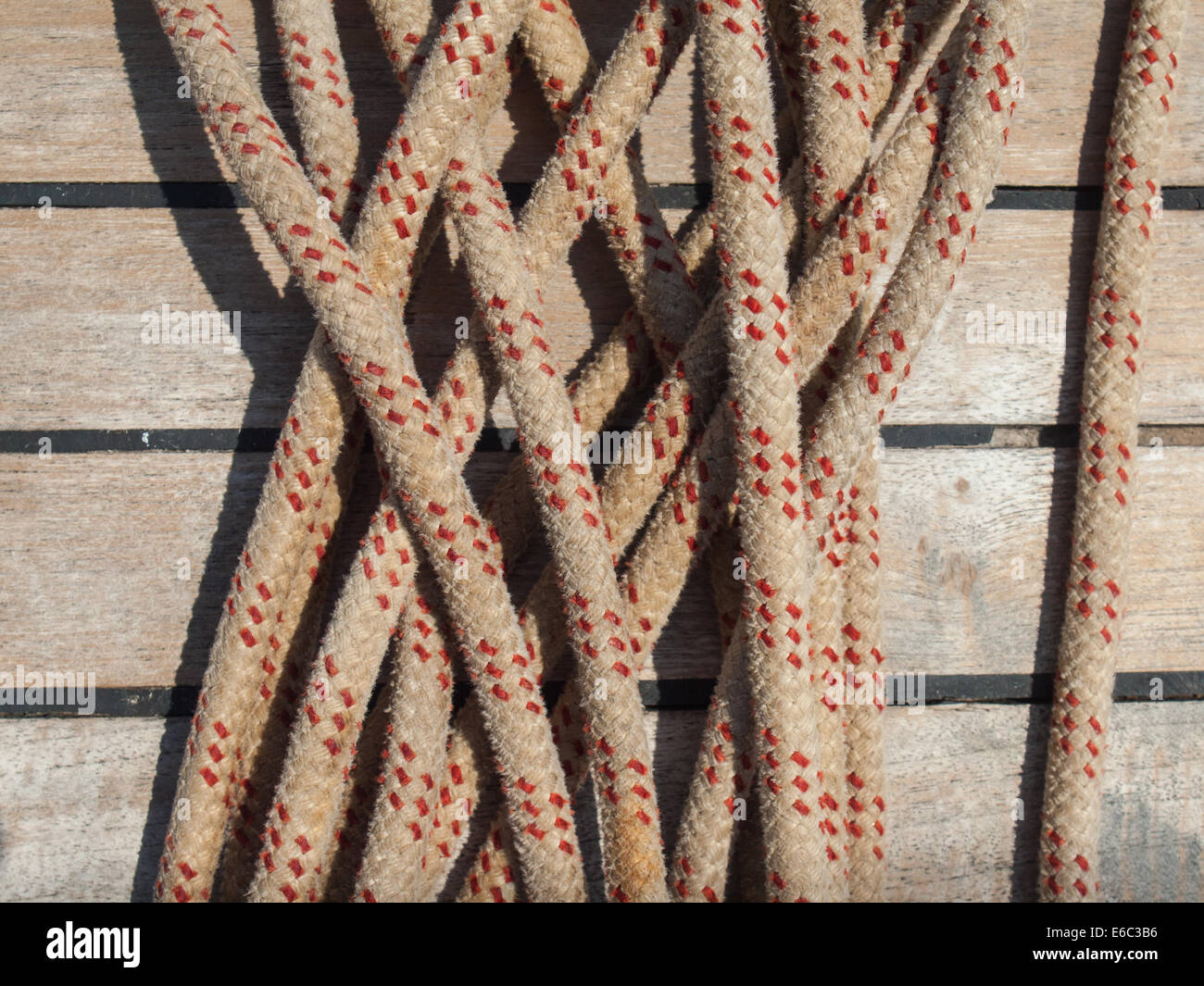 detail of ships rope with teak deck behind Stock Photo