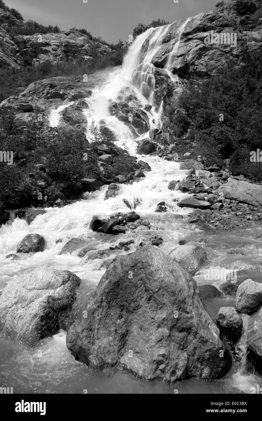 Alpine waterfall in mountain Stock Photo
