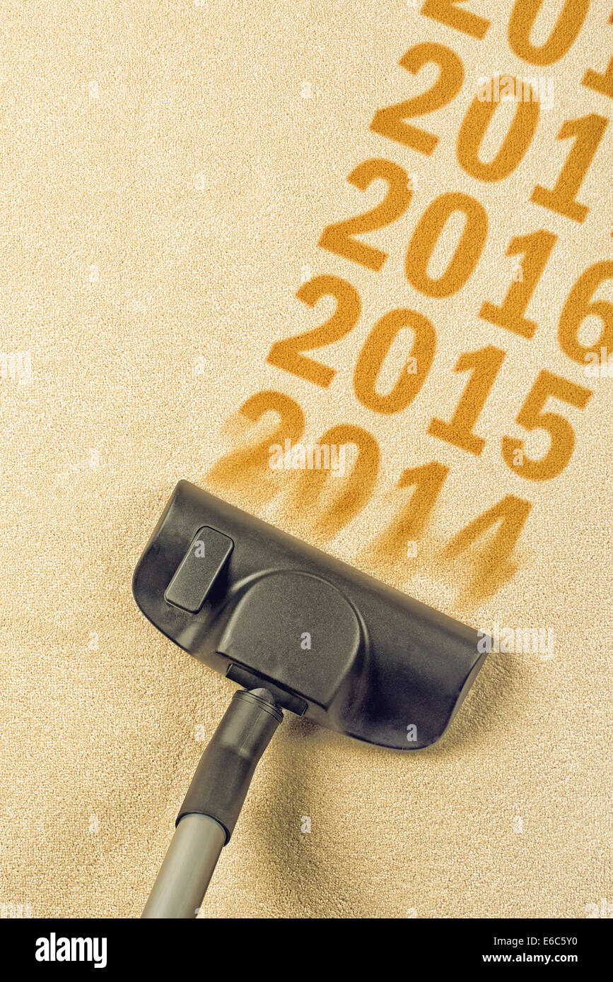 Vacuum Cleaner sweeping year number 2014 from Brand New Carpet leaving sequence 2015, 2016... Happy New 2015 year concept Stock Photo