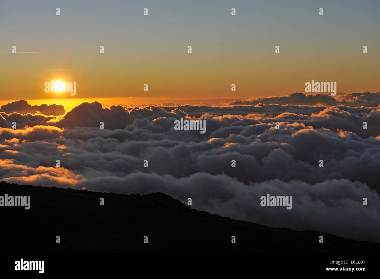 Sunset above clouds - Cloudscape at sunset, Maui Island, Hawaii Islands, USA Stock Photo