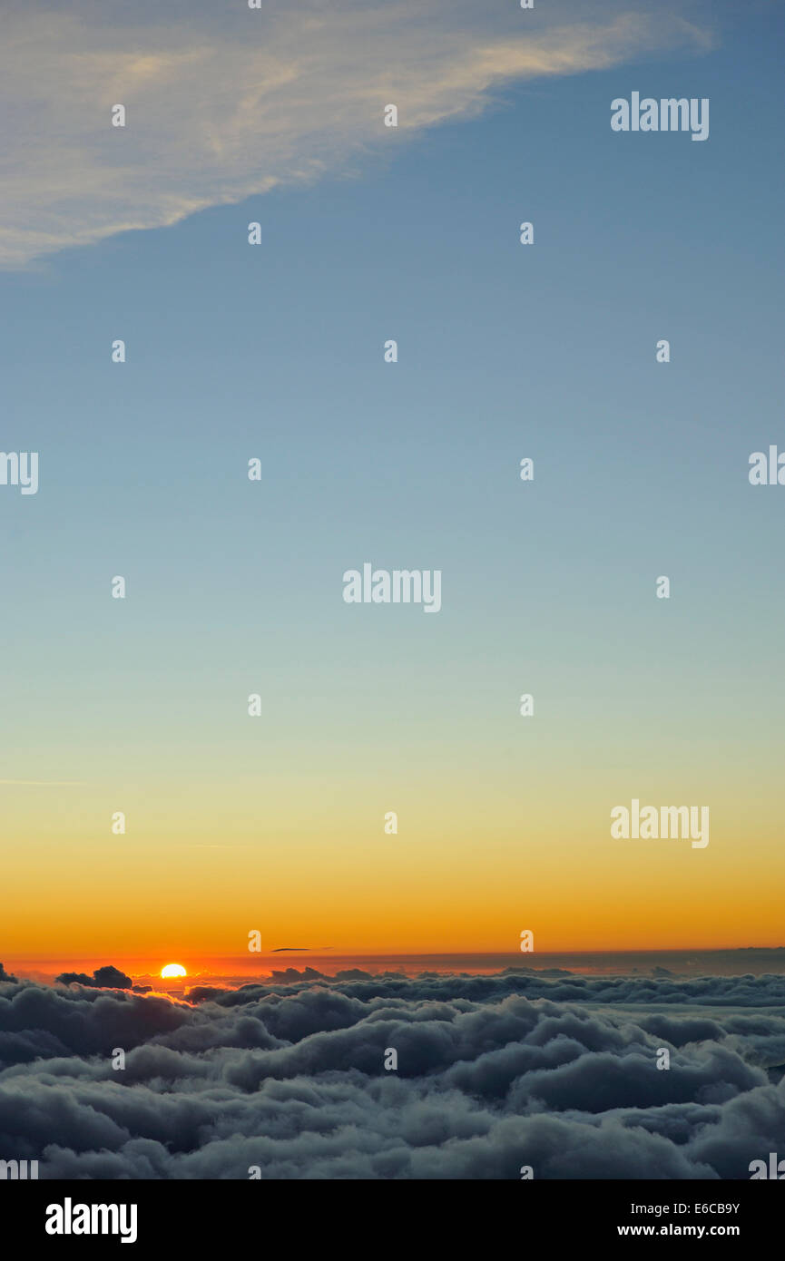 Sunset above the cloud - Cloudscape with sun dipping below the clouds Stock Photo