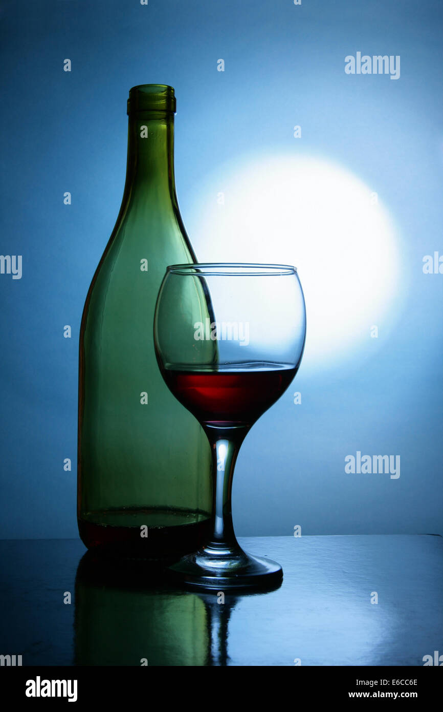 Still life with bottle and glass of red wine Stock Photo - Alamy