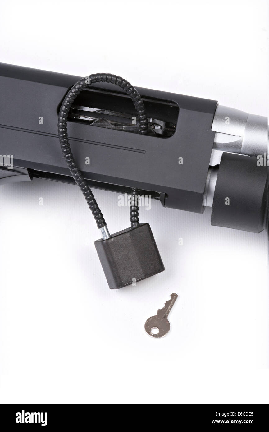 Shotgun with safety cable lock installed in open receiver isolated on white background Stock