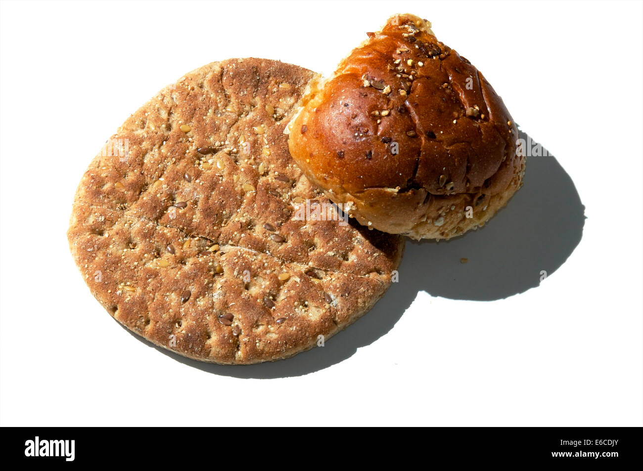 A small loaf of multigrain flat bread and a multigrain roll from above