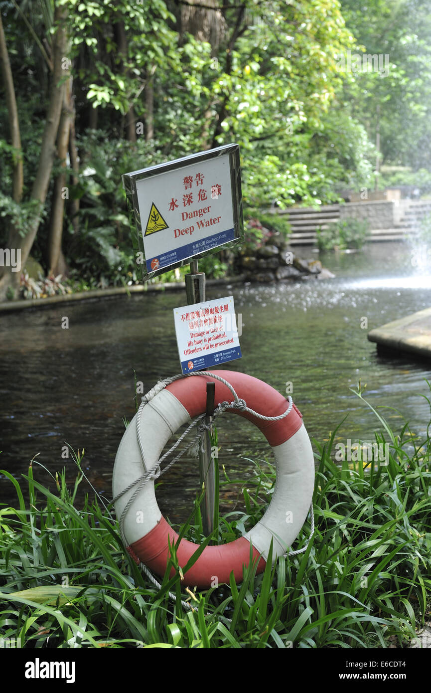 Life preserver and warning signs, Kowloon Park, Kowloon, Hong Kong, China Stock Photo