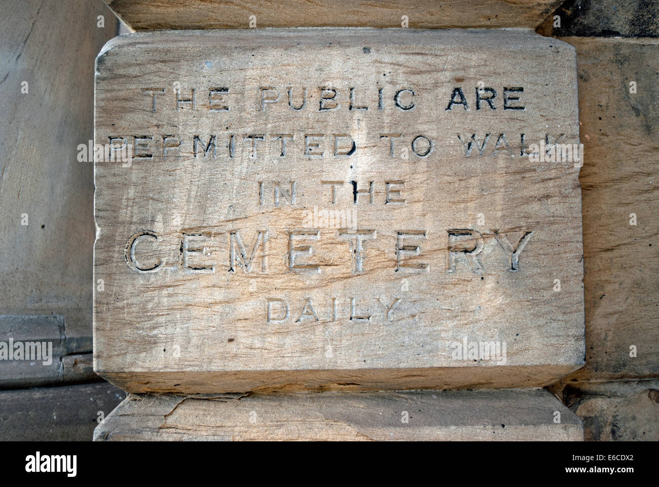 the public are permitted to walk in the cemetery daily, notice etched in entrance wall of  brompton cemetery, london, england Stock Photo