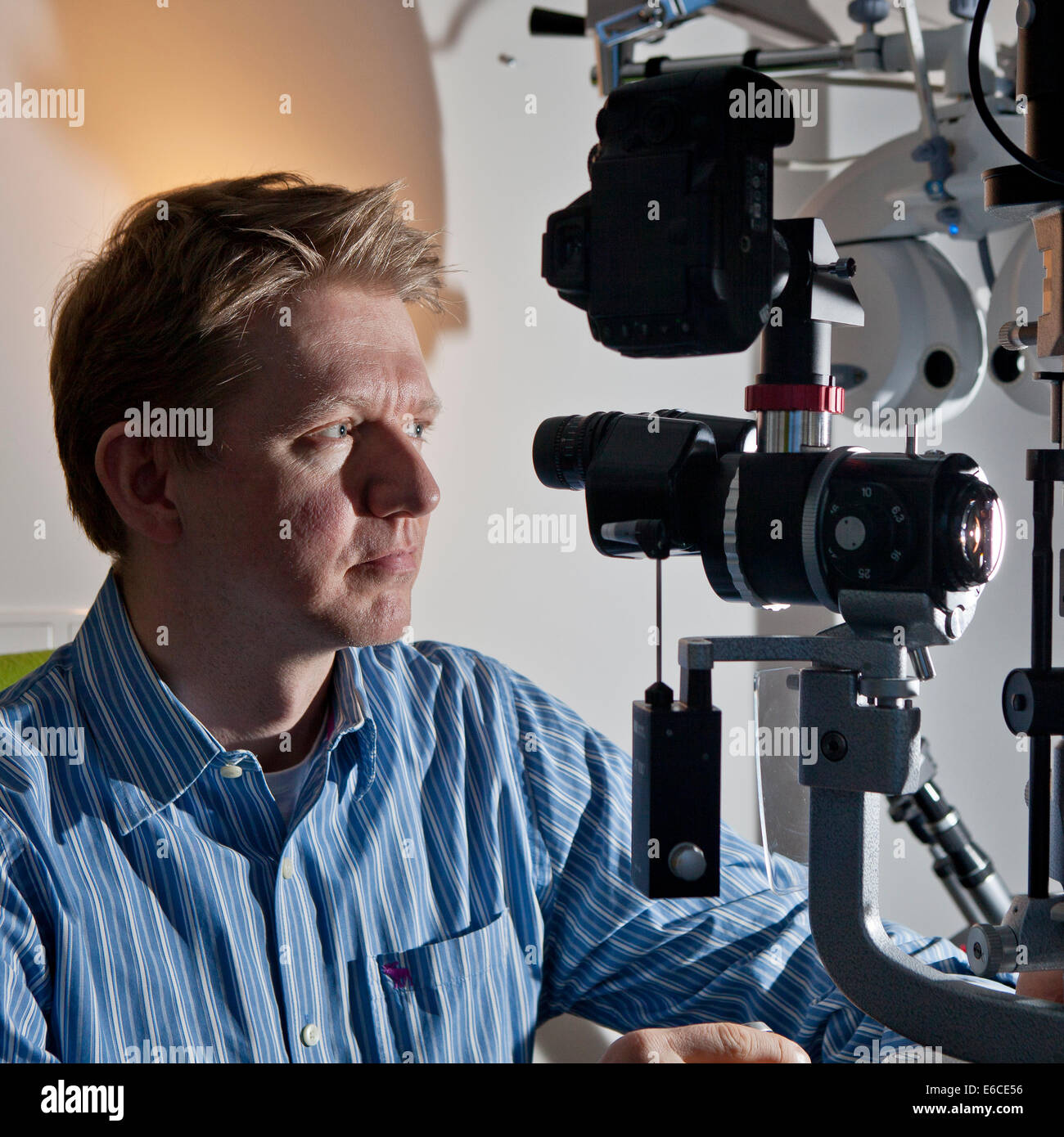 Portrait of doctor with equipment used for Laser (Lasik) eye surgery. Stock Photo