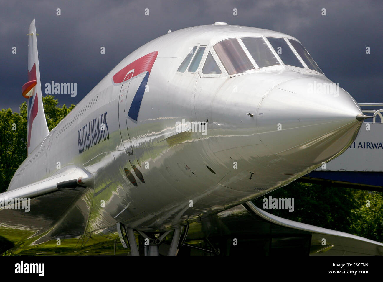 British Airways Concorde rests peacefully at Manchester airport, as a thunderstorm approaches. Stock Photo