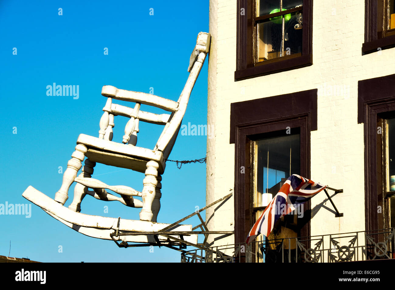 Rocking chair on a building Stock Photo - Alamy