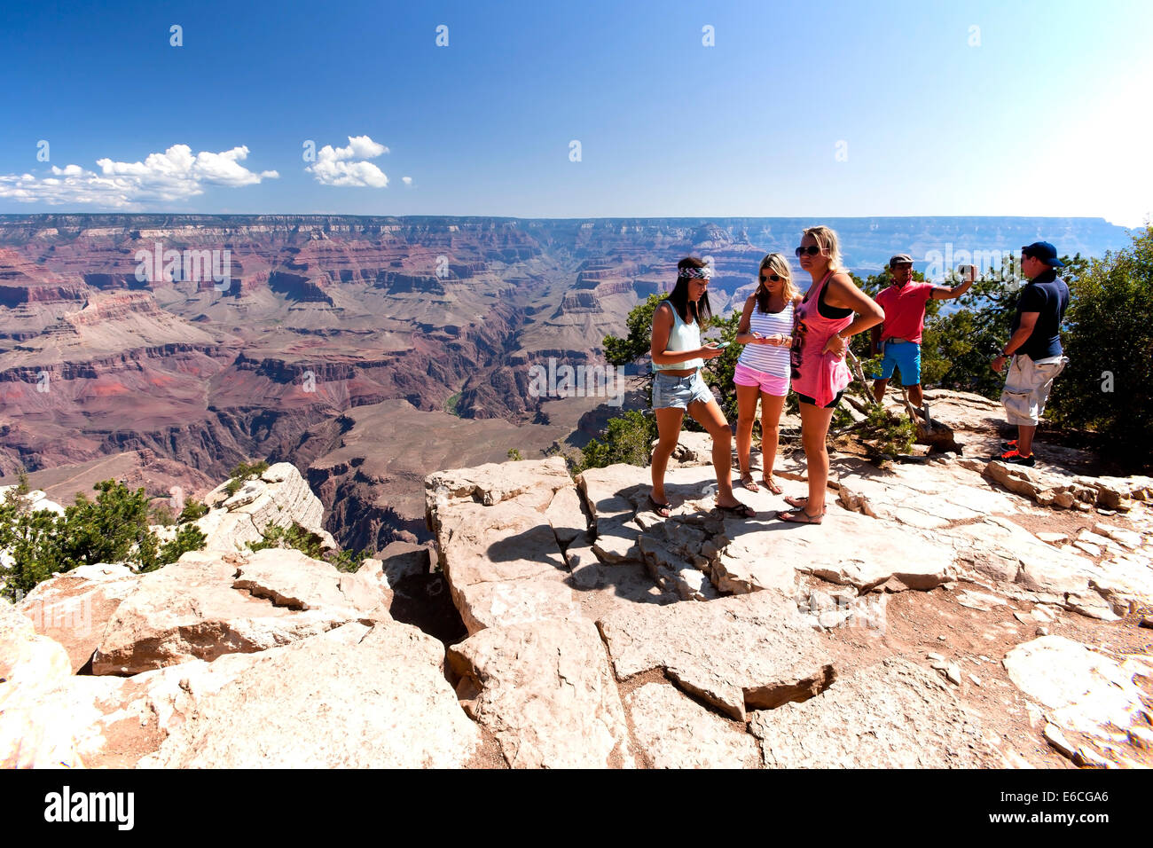 Group of Tourists enjoy the view from the South Rim of Grand Canyon Stock Photo