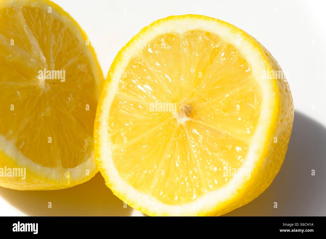 A lemon cut in half outside on a sunny day Stock Photo Alamy