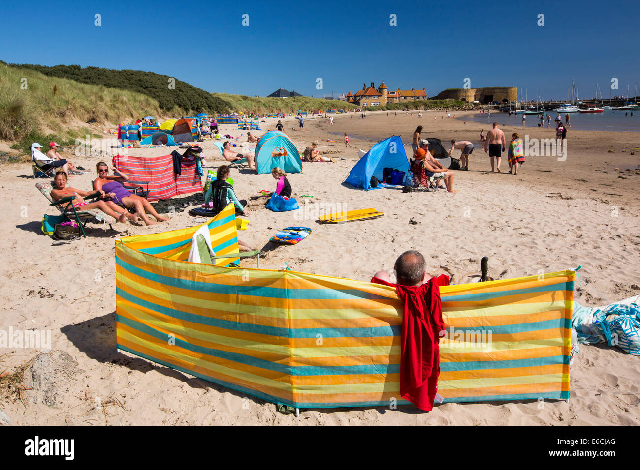 A busy summers day on Beadnell beach, Northumberland, UK. Stock Photo