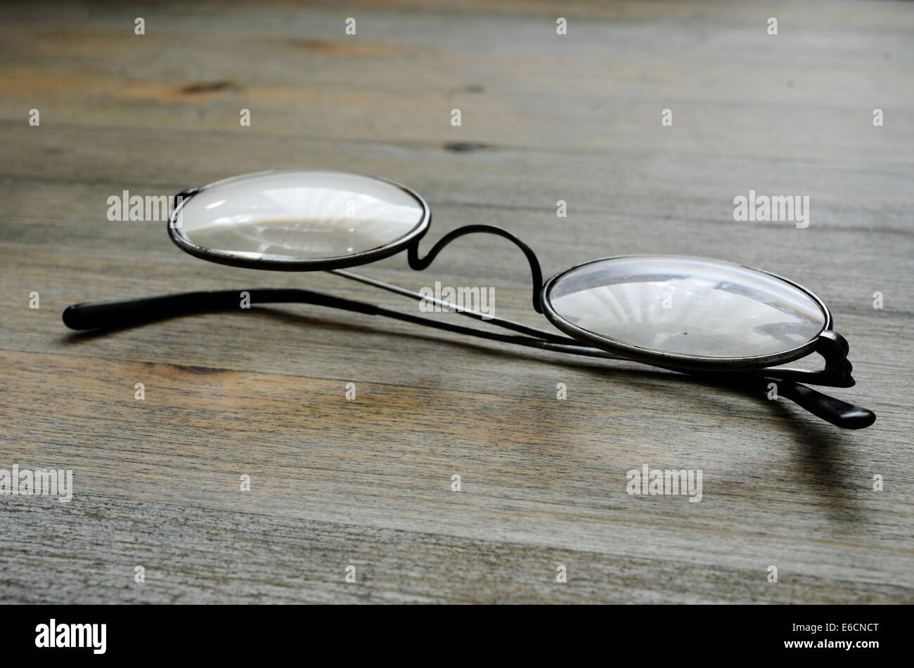 pair of vintage spectacles on wooden background Stock Photo