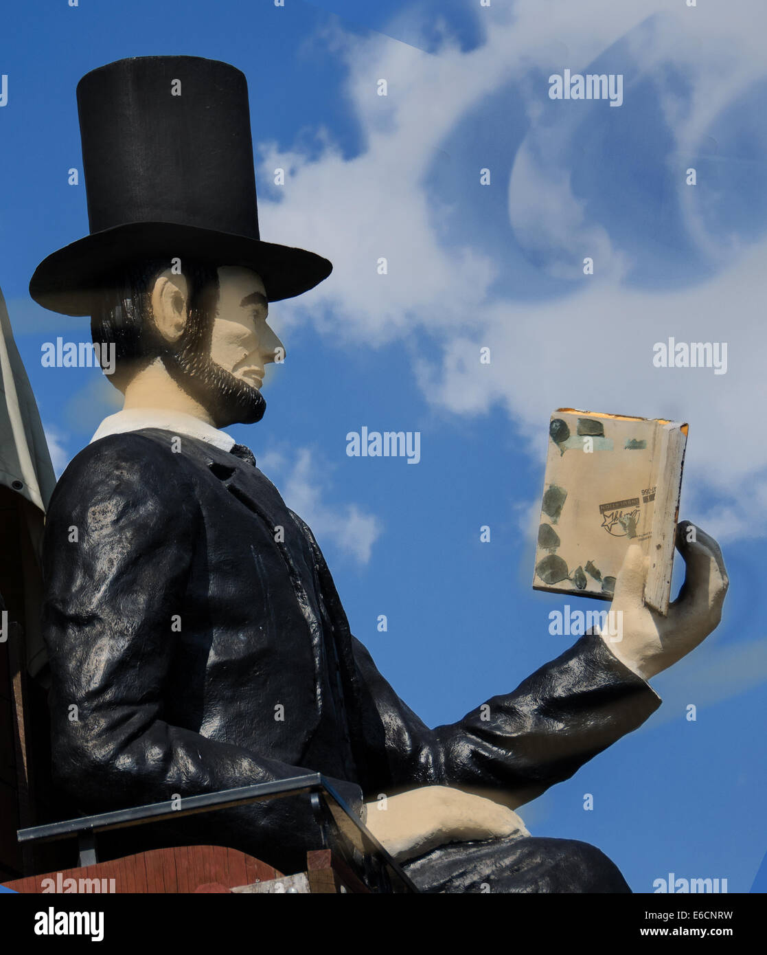 The Railsplitter Covered Wagon features Abraham Lincoln sitting on a covered wagon reading a book. Stock Photo