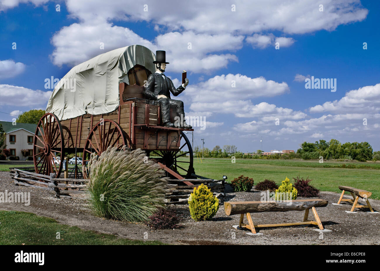 The Railsplitter Covered Wagon features Abraham Lincoln sitting on a covered wagon reading a book. Stock Photo