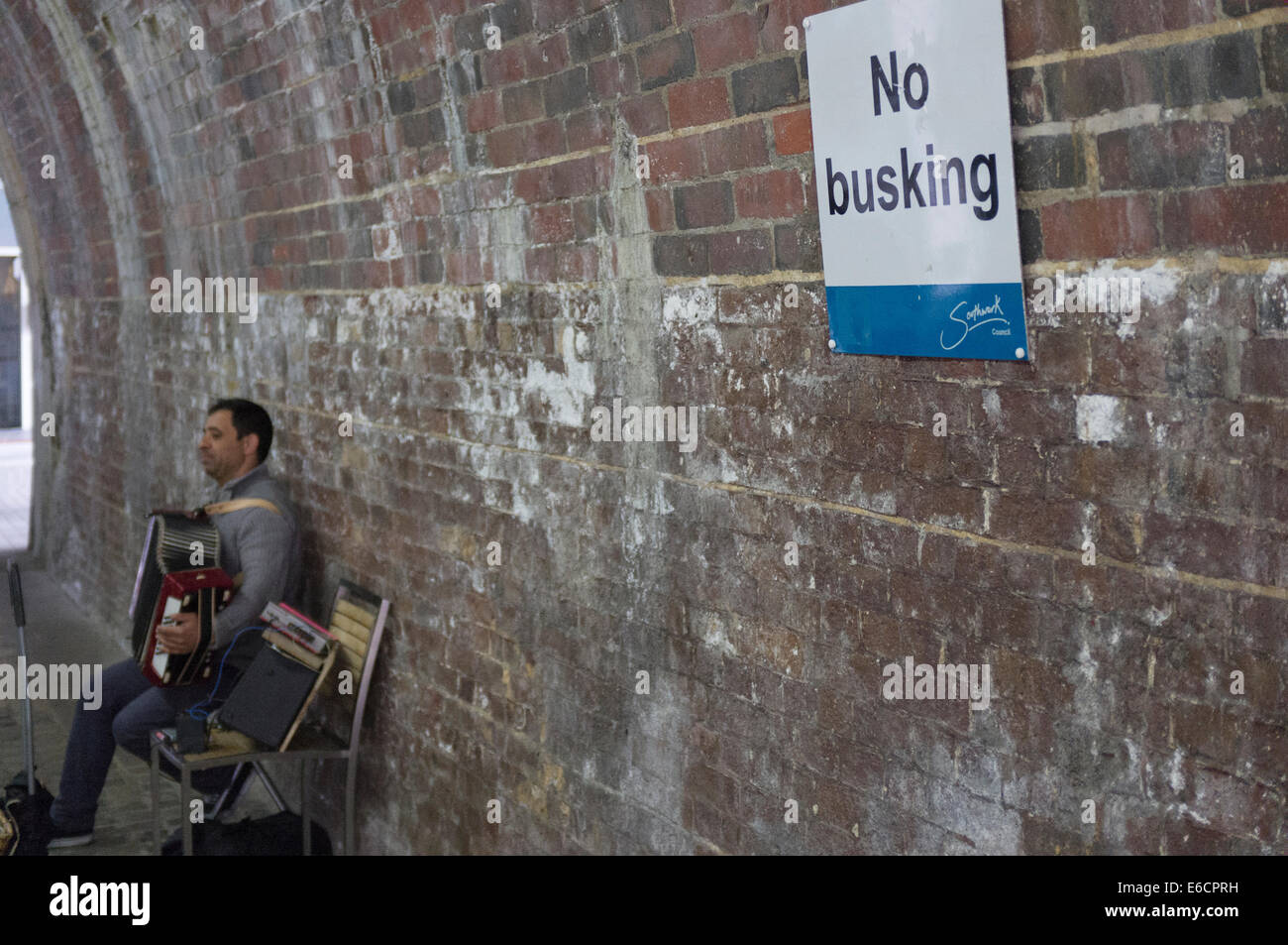 Eastern European male busking in tunnel in London's southbank near Borough Market, UK Stock Photo