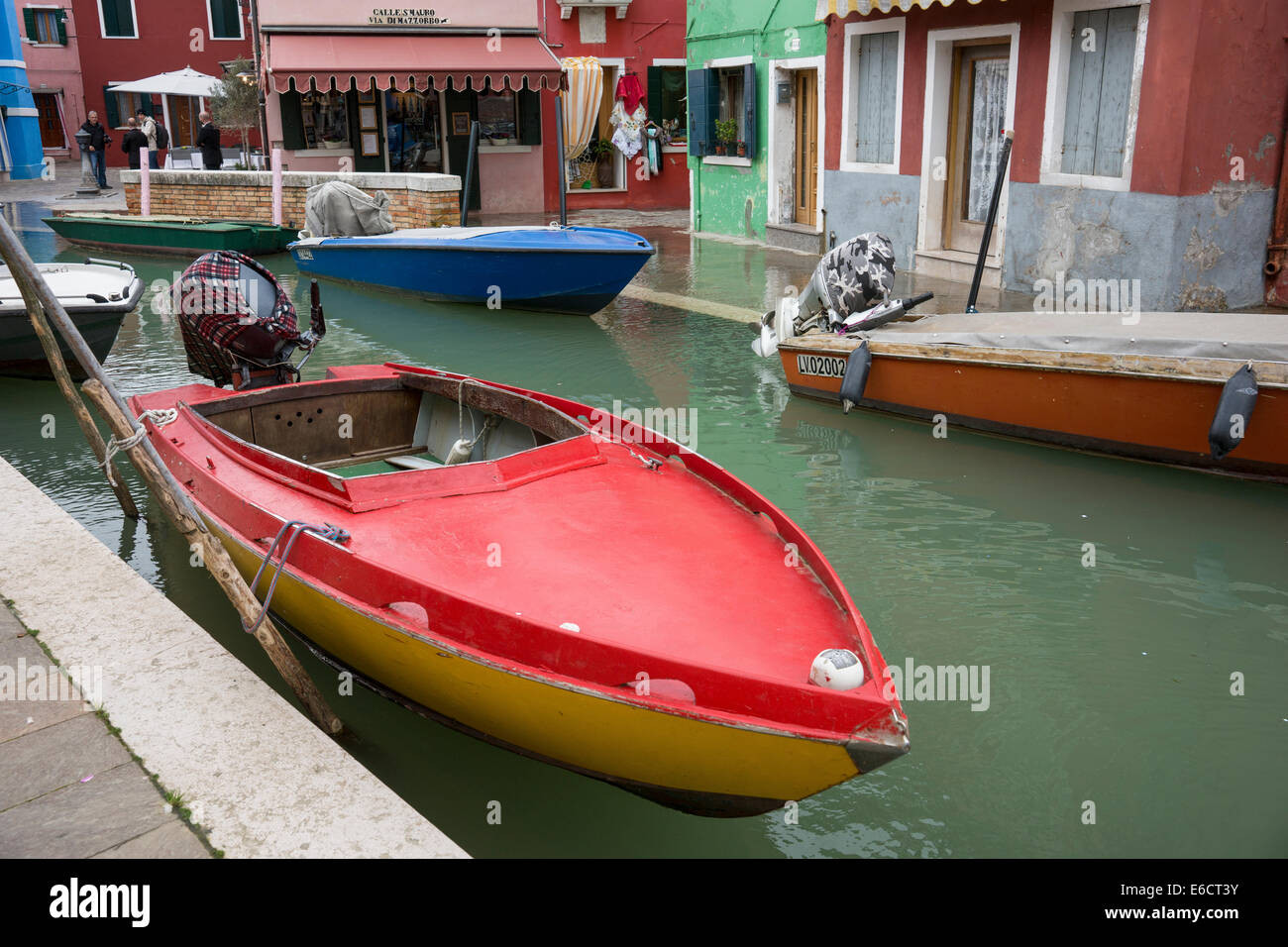 Motors boats along the flooding main canal of the Island of Burano in