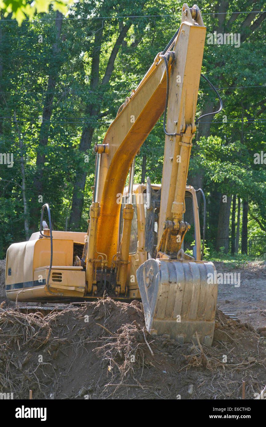 An earthmover with a large shovel attached sits idle on a construction site Stock Photo