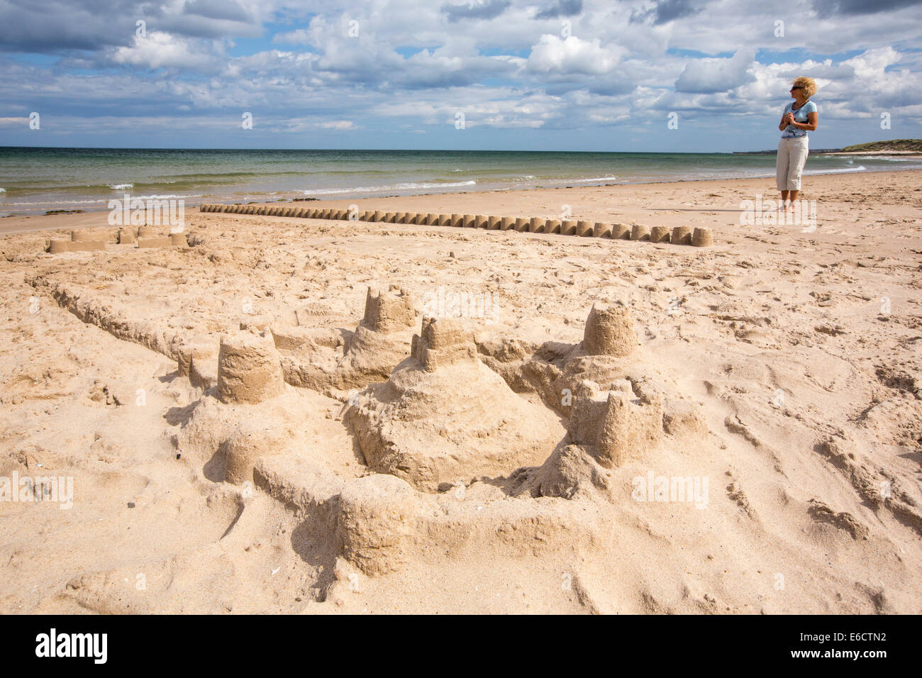 A line of sandcastles on a beach in Northumberland, UK. Stock Photo