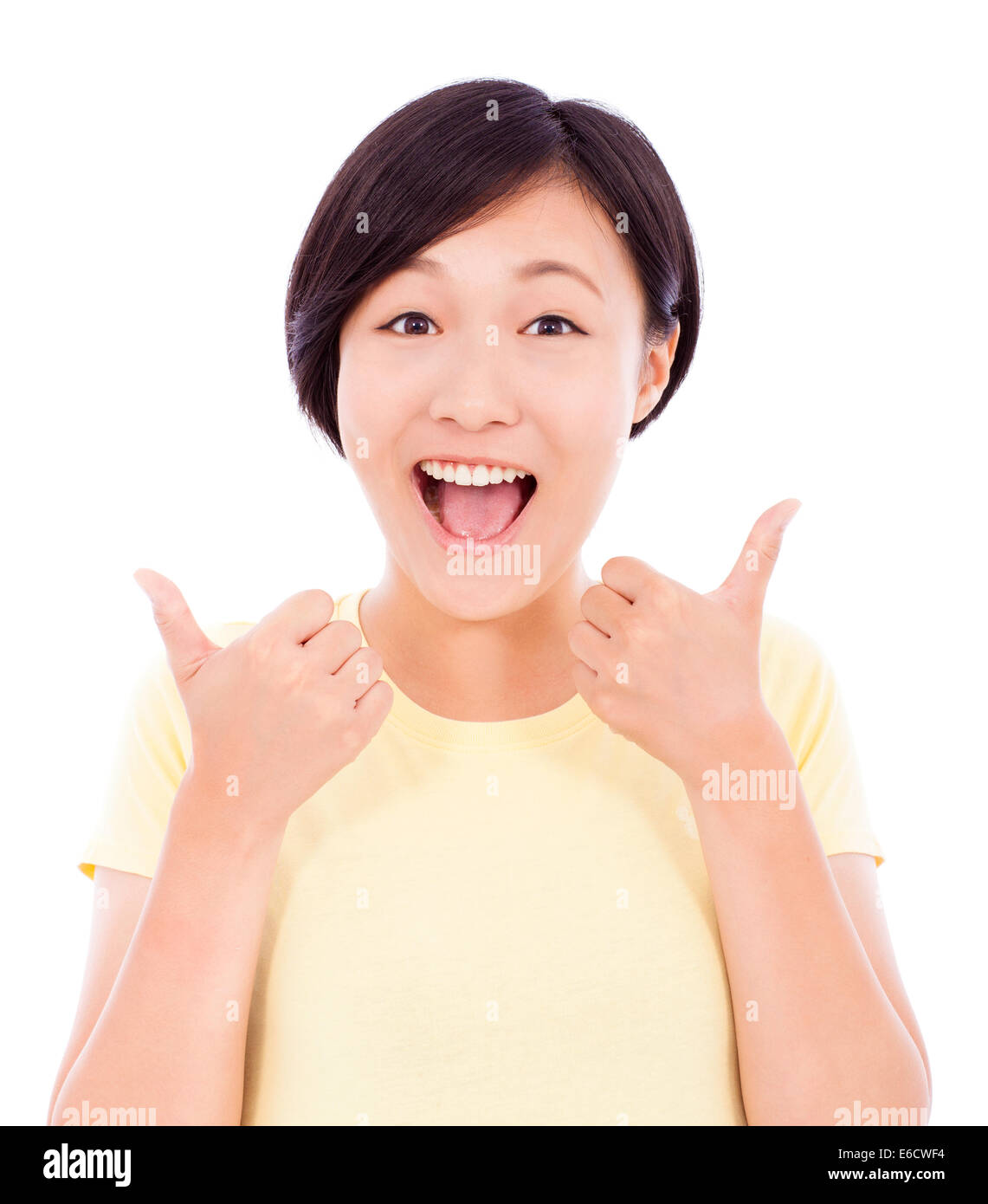 cheerful  young woman standing and thumb up Stock Photo
