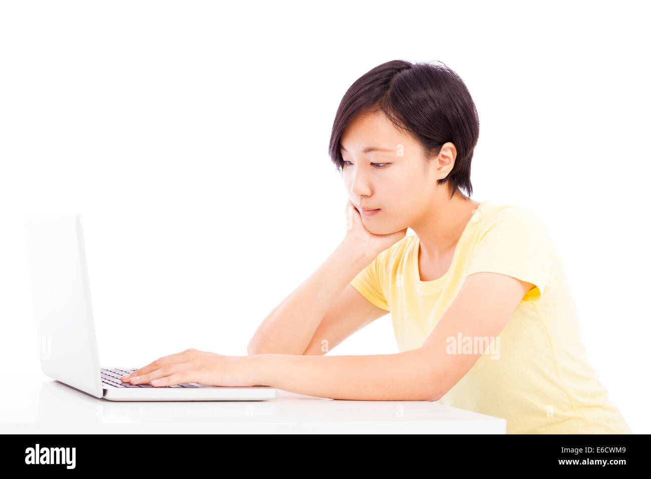tired woman in front of a laptop, isolated on white background Stock Photo