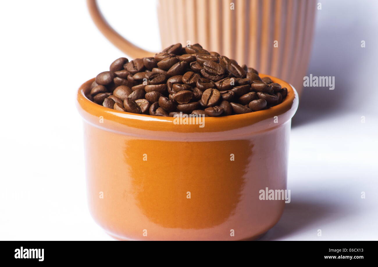 Roasted coffee beans in a bowl on white background Stock Photo - Alamy