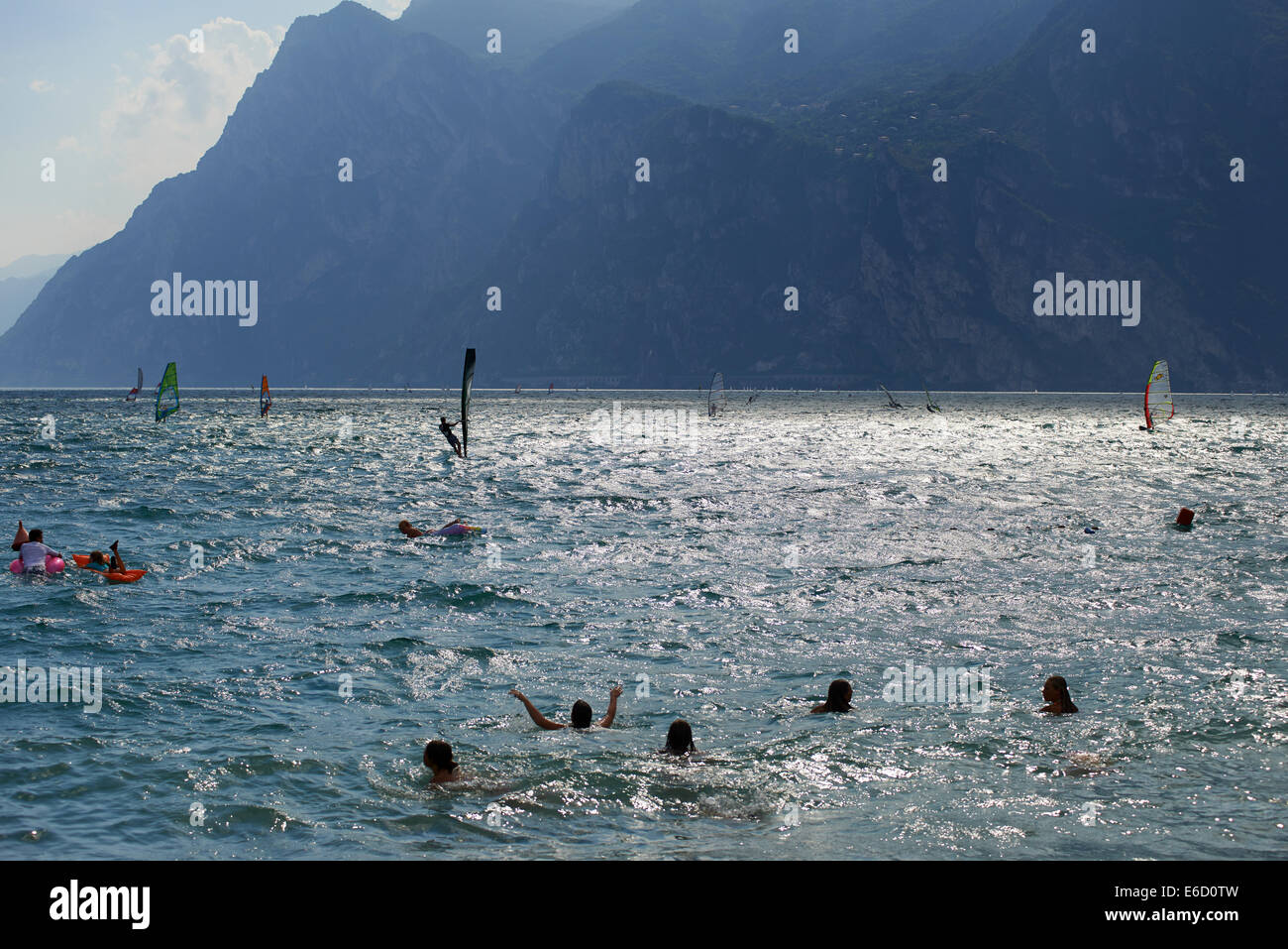 Windsurfers on Lake Garda near Torbole, Lago di Garda, Torbole, Nago, Italy, Europe, Windsurfing, aquatic sport , Alps mountains Stock Photo