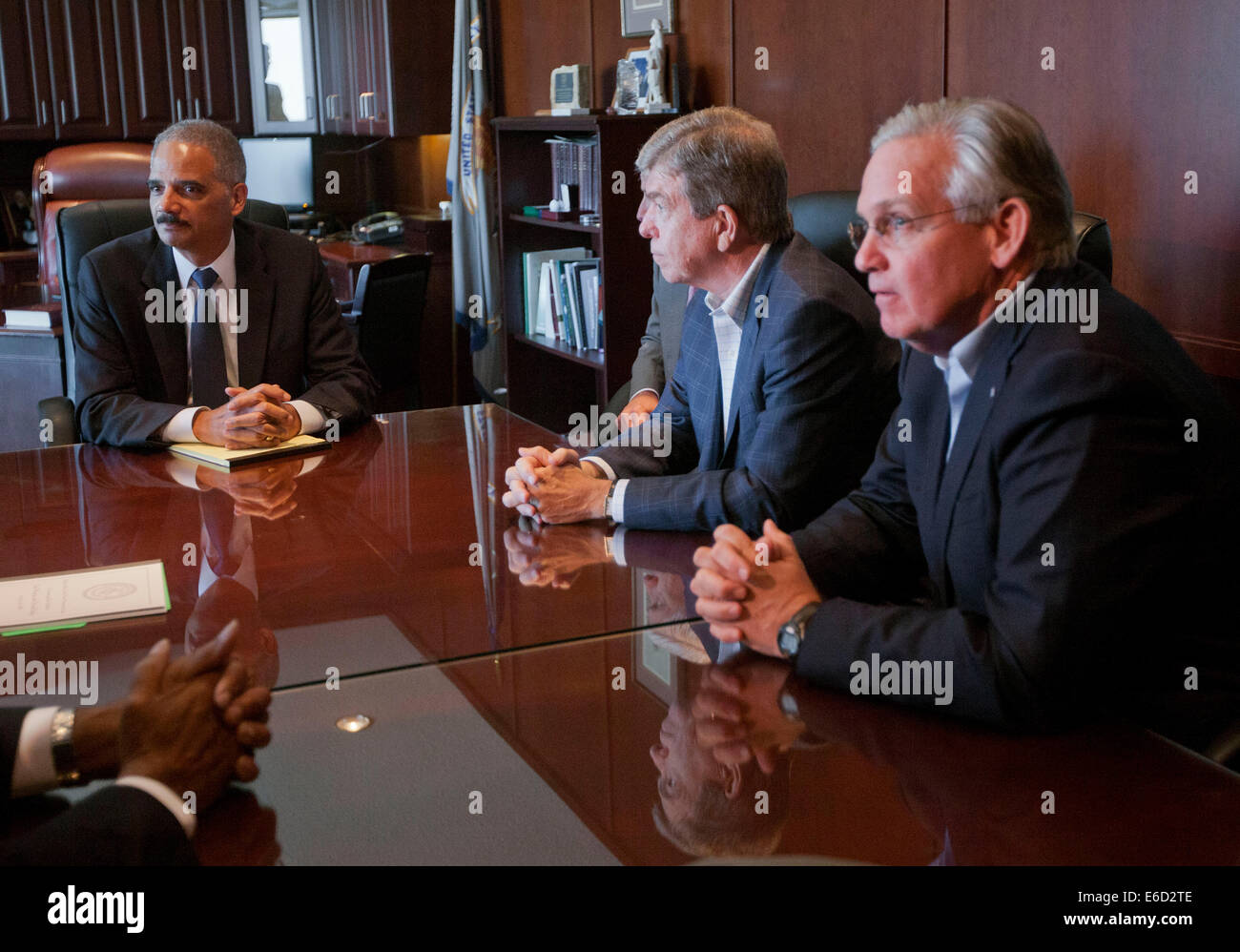 Ferguson, Mo. 20th Aug, 2014. United States Attorney General Eric Holder, left, during his meeting with U.S. Sen. Roy Blunt, R-Mo., center, Missouri Gov. Jay Nixon, right, and other elected officials at the US Attorney's office in St. Louis, Mo., Wednesday, Aug. 20, 2014. Holder traveled to the St. Louis-Area to oversee the federal government's investigation into the shooting of 18-year-old Michael Brown by a police officer on Aug. 9th. Credit:  dpa picture alliance/Alamy Live News Stock Photo