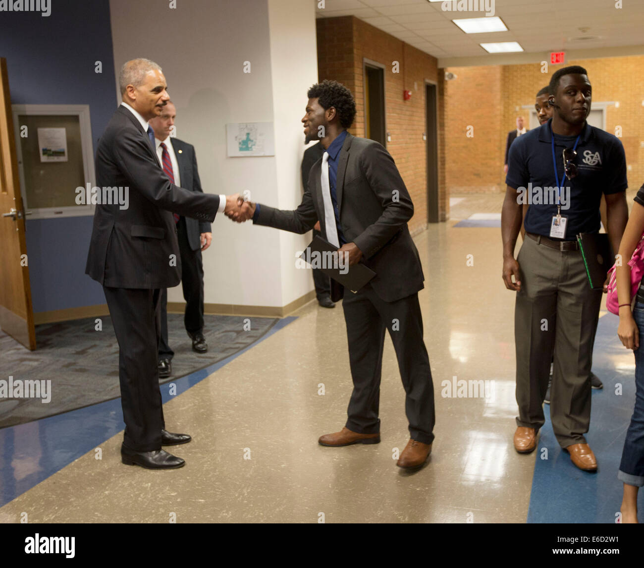 Ferguson, Mo. 20th Aug, 2014. United States Attorney General Eric Holder, left, shakes hands with Bradley J. Rayford, 22, right, following his meeting at St. Louis Community College Florissant Valley, Wednesday, Aug. 20, 2014 in Ferguson, Mo. Holder traveled to the St. Louis-Area to oversea the federal government's investigation into the shooting of 18-year-old Michael Brown by a police officer on Aug. 9th. Holder promised a 'fair and thorough' investigation into the fatal shooting of a young black man, Michael Brown Credit:  dpa picture alliance/Alamy Live News Stock Photo