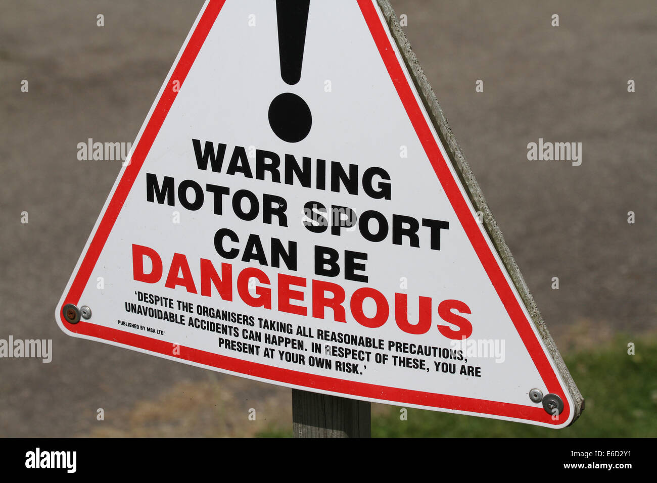 Danger warning sign on motor racing track. Stock Photo