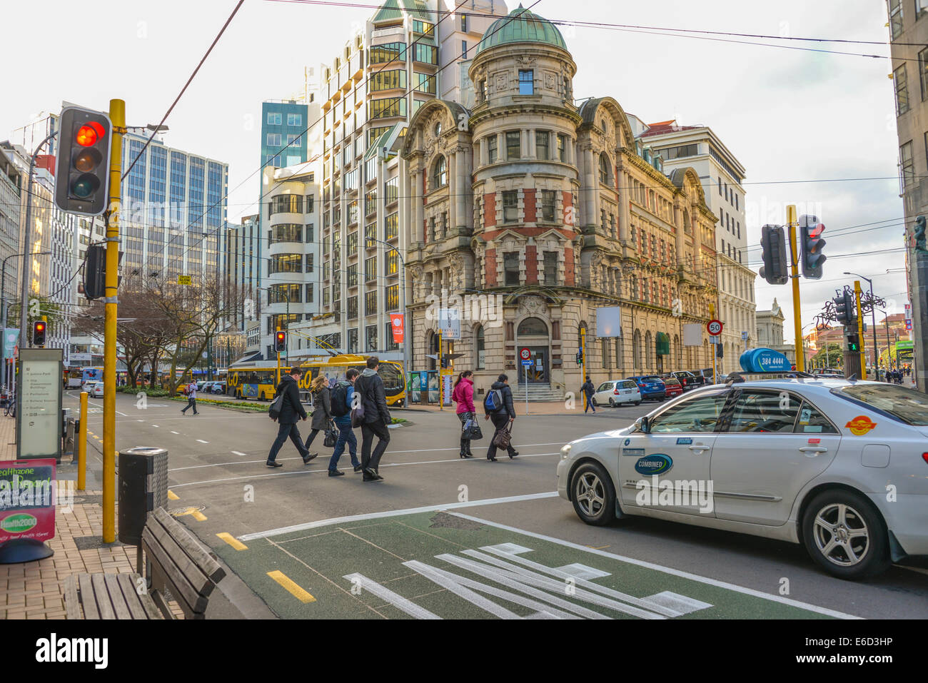 main street wellington city new zealand with pedestrians walking across