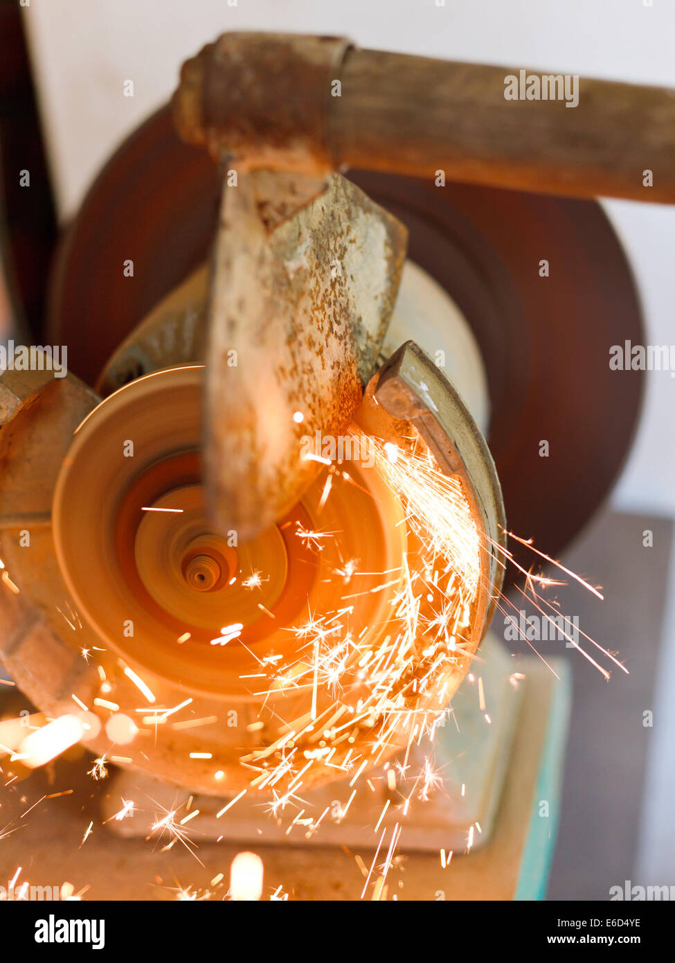 grinding garden hoer using a grinding machine close up Stock Photo