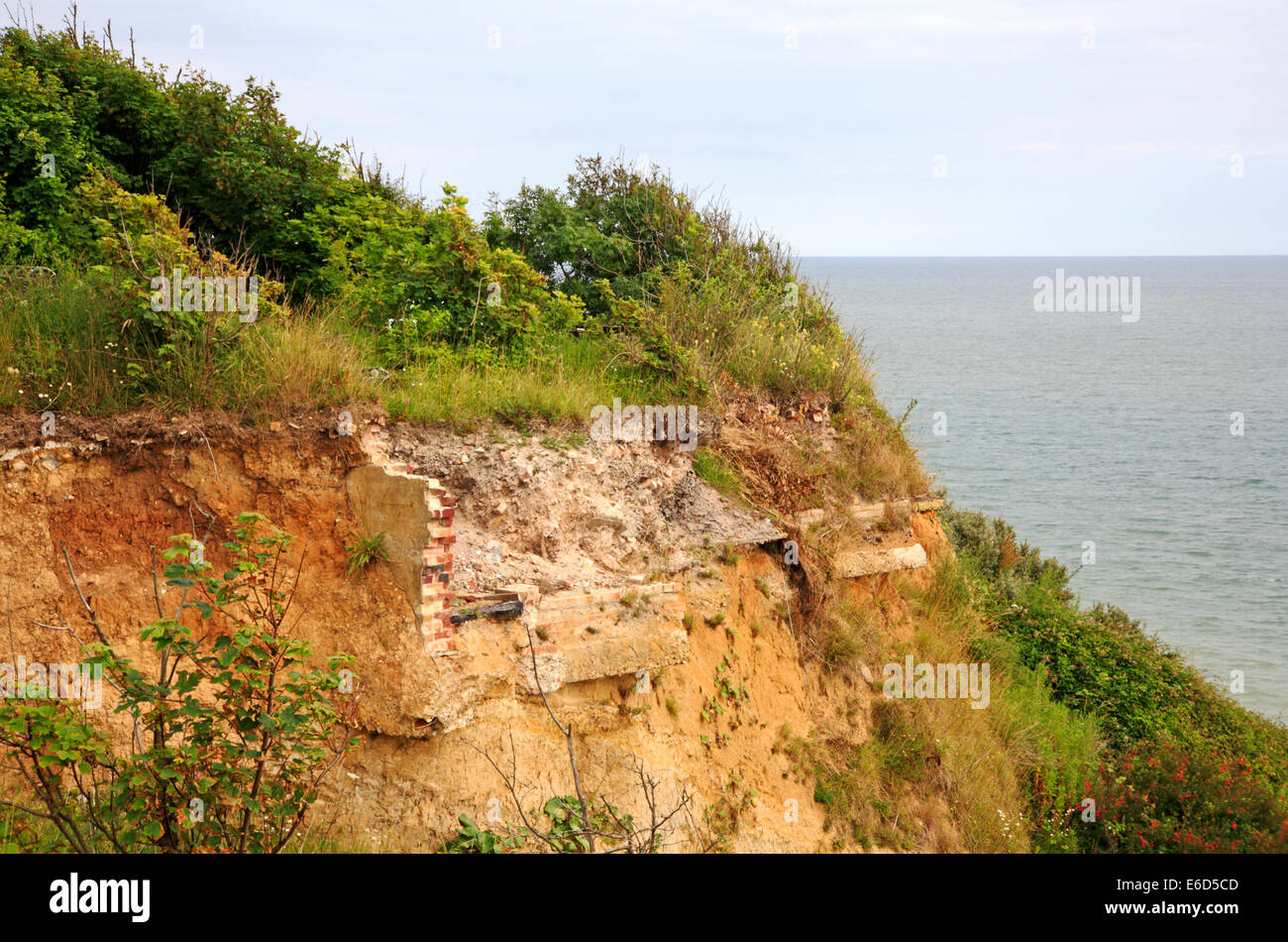 Building foundations revealed by cliff erosion on the east coast at