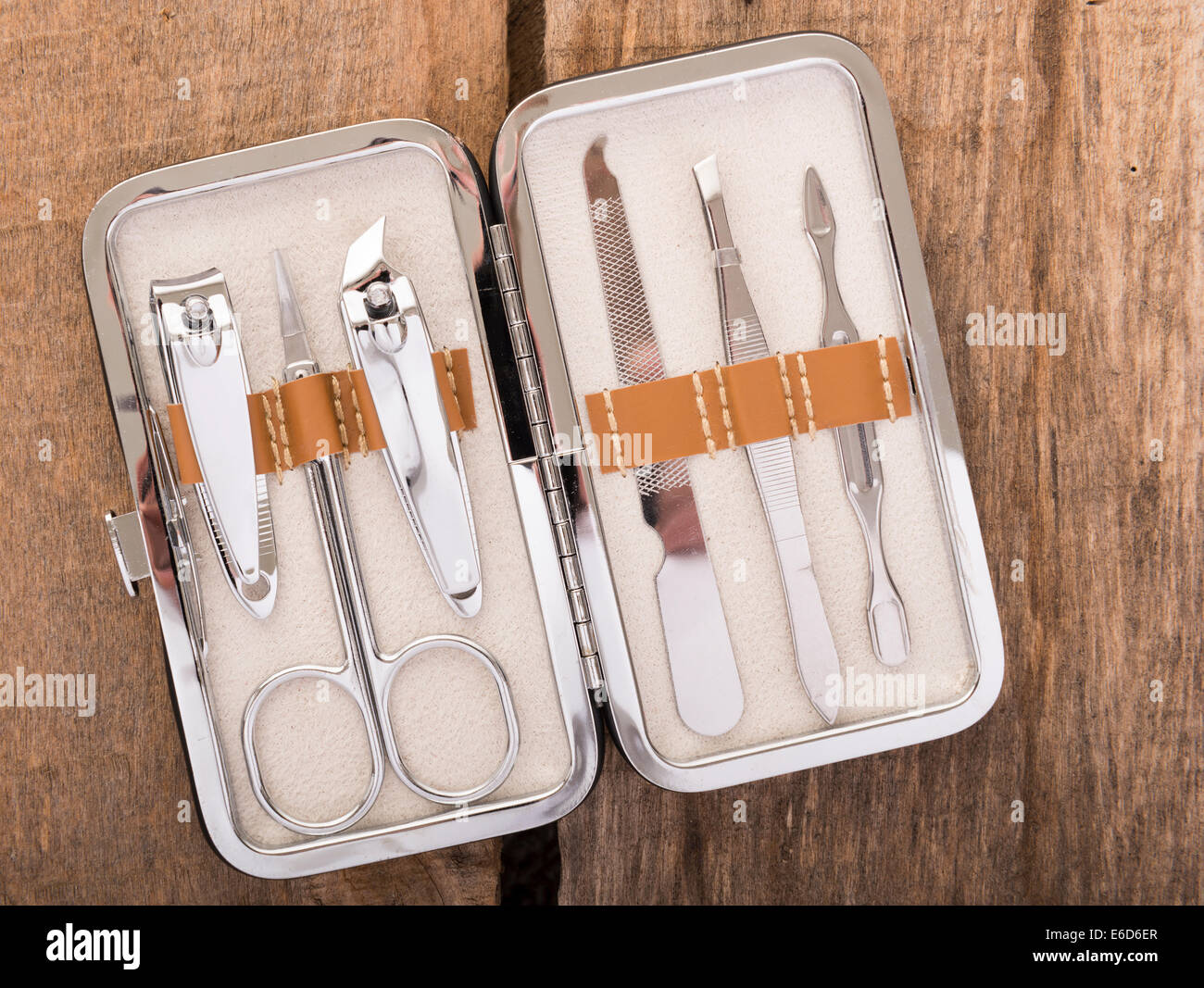 Classic metal kit of nail scissors and manicure tools on wooden background Stock Photo