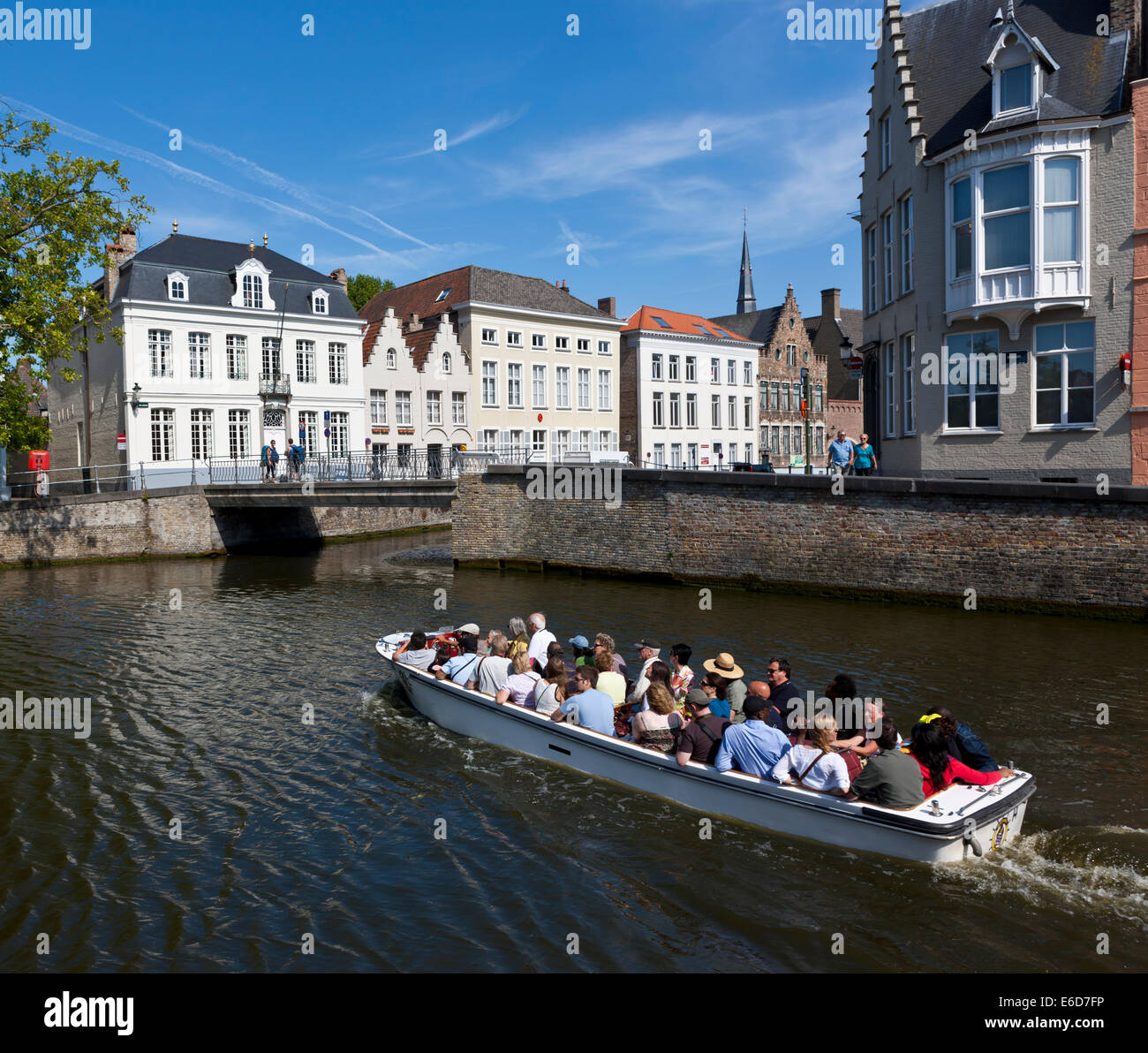 Belgium, Flanders, West Flanders, Bruges, excursion boat with tourists on sightseeing Stock Photo