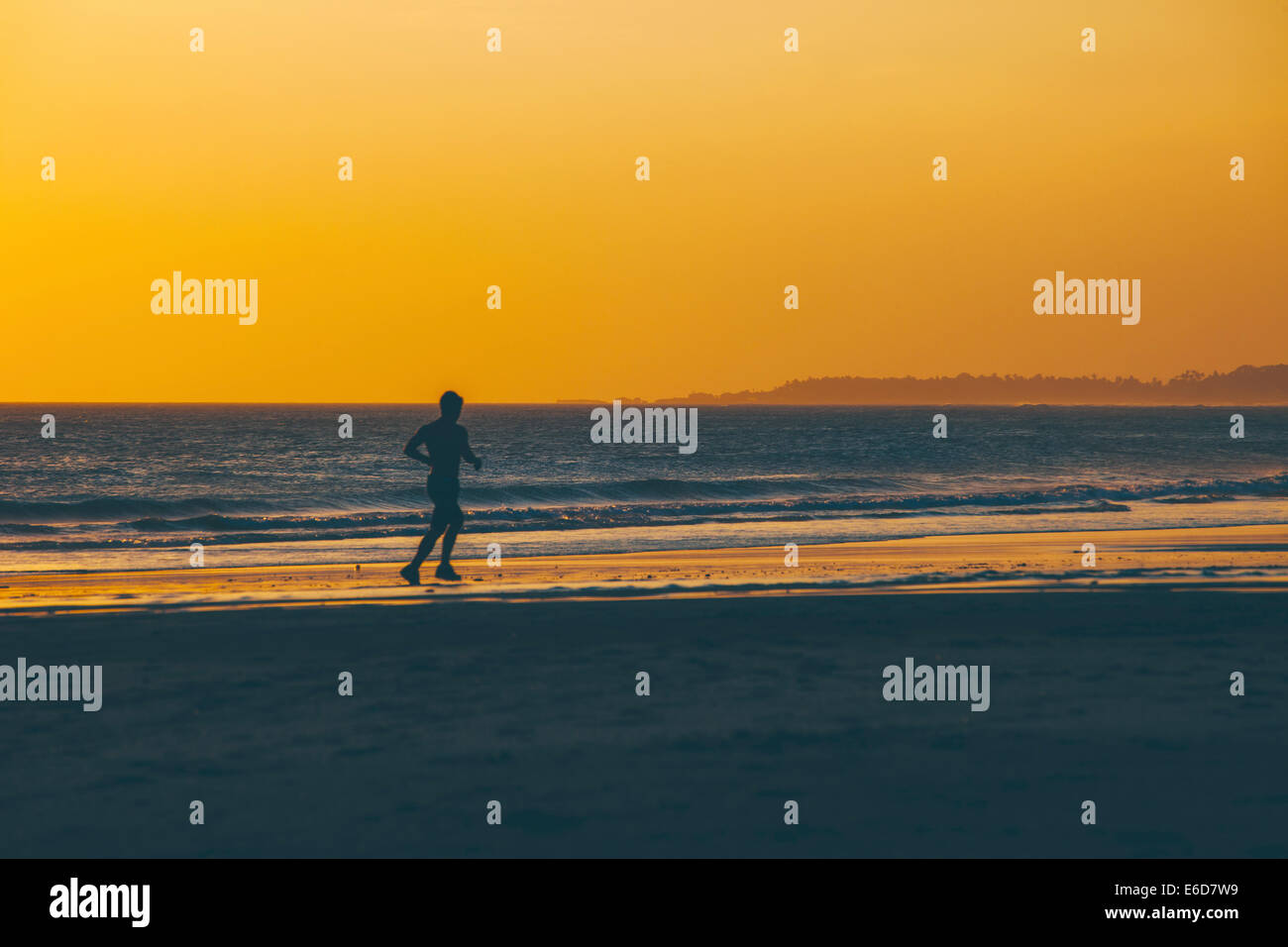 Indonesia, Bali, man jogging on the beach at sunset Stock Photo