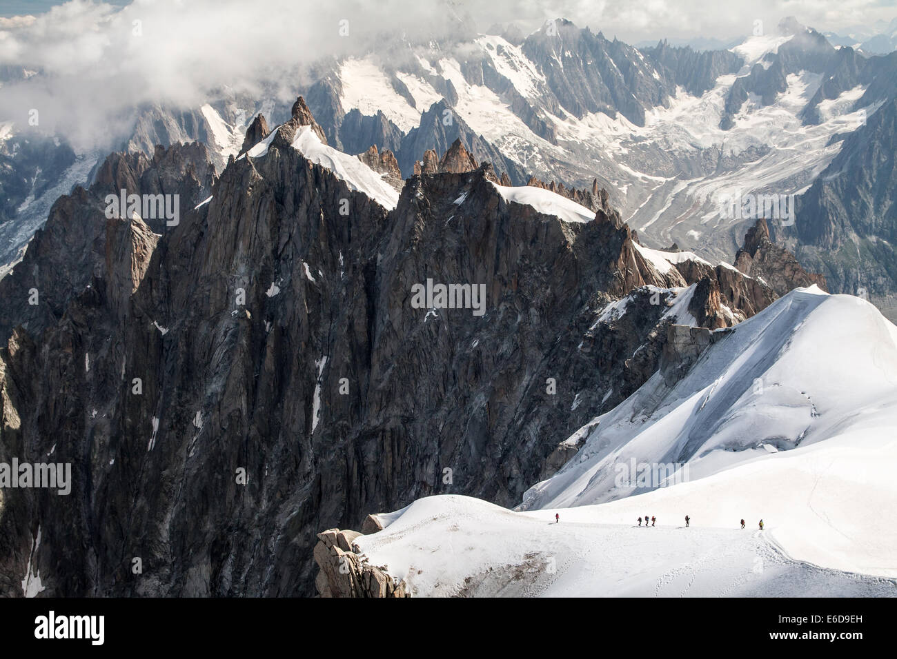 Panorama with a group of hikers climb to the top of Mont Blanc mountain, Aiguille du Midi in France Stock Photo
