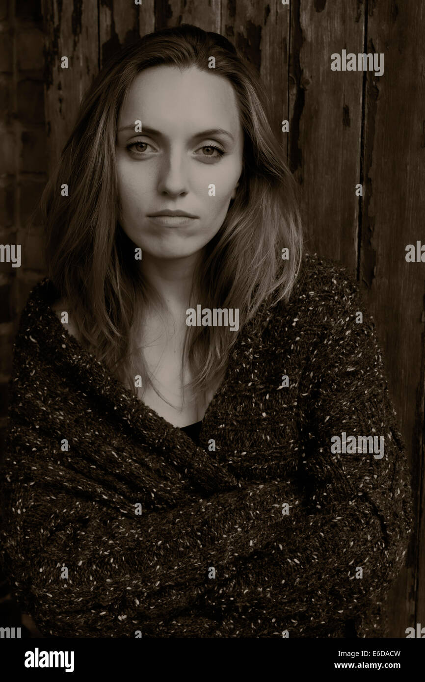 Portrait of a young woman in front of a wooden door Stock Photo - Alamy