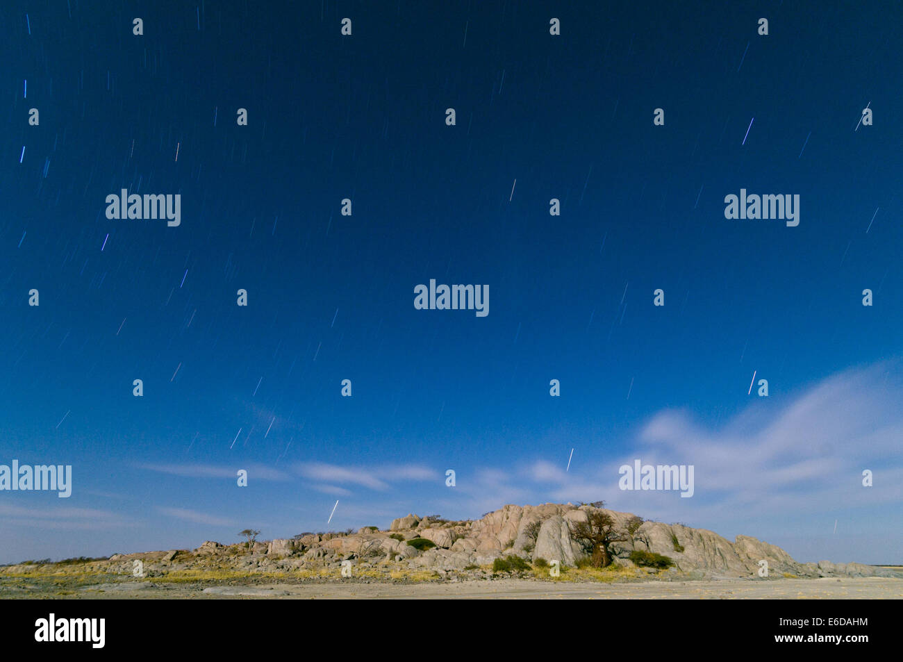 Star trails over Kubu Island (Lekhubu) at night, Magkadigkadi Pan, Botswana Stock Photo