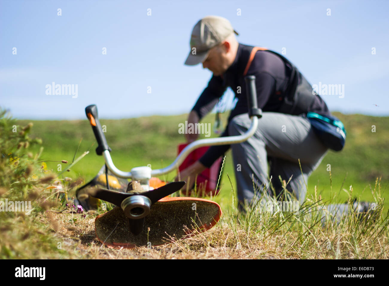 A member of WIldlife Trust staff prepares his brush cutter in order to carry out important maintenance work, keeping access to t Stock Photo