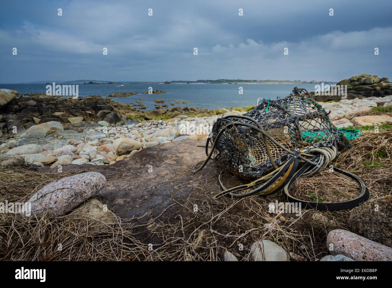 An old lobster pot is washed up on the shore of the uninhabited island of Annet, on the Isles of Scilly. Stock Photo