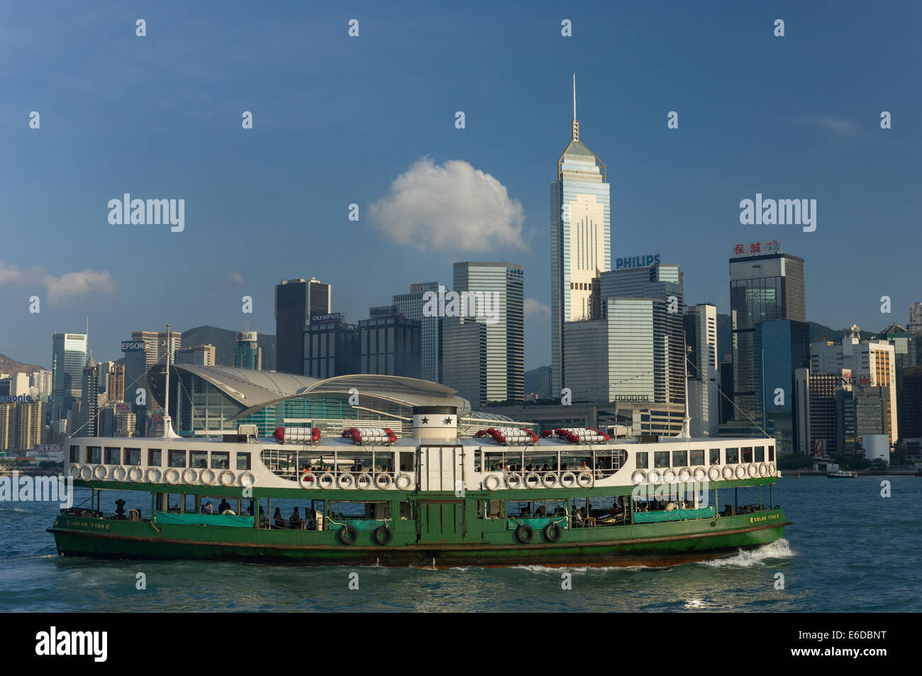 Star Ferry passing the Hong Kong Convention and Exhibition Centre and the tower blocks of the Wan Chai district of Hong Kong Island, Hong Kong, China Stock Photo