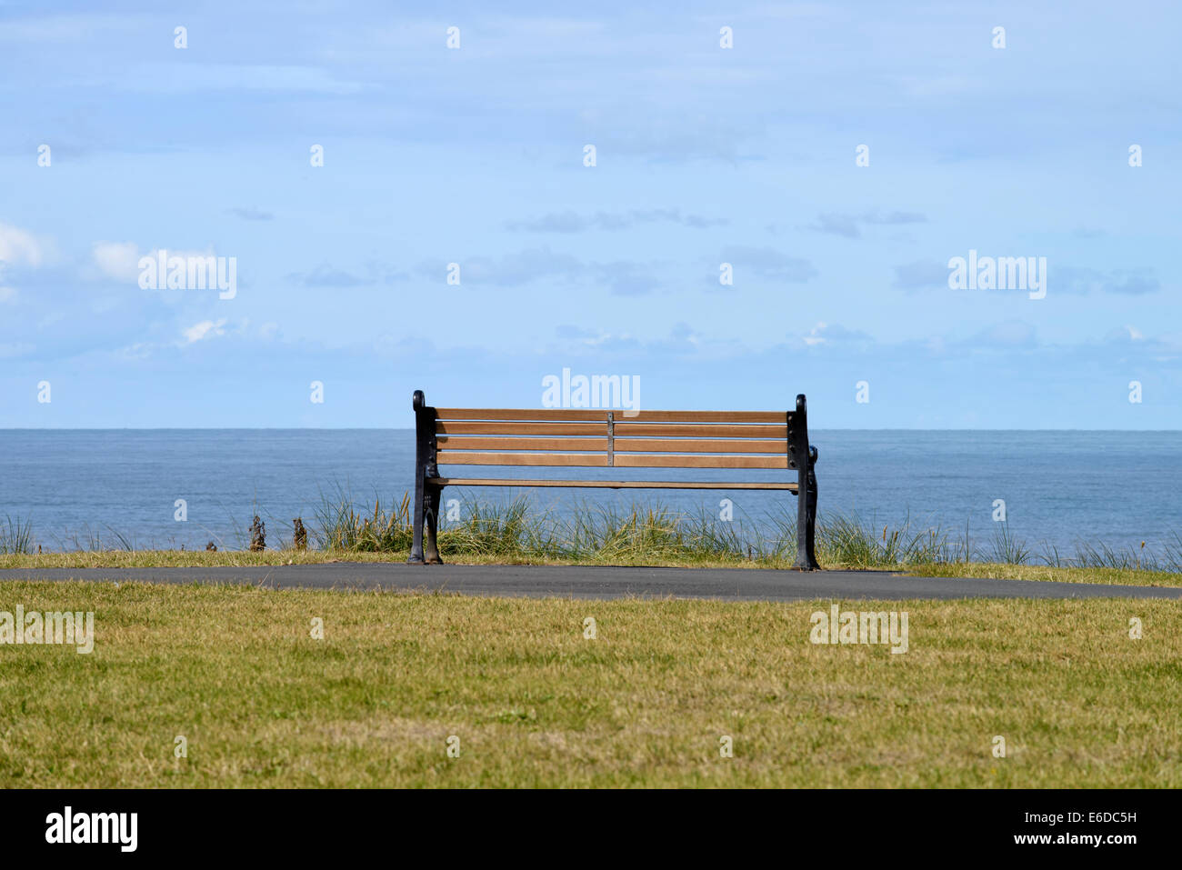 Empty wooden bench on seafront in Blackpool, Lancashire, England Stock Photo