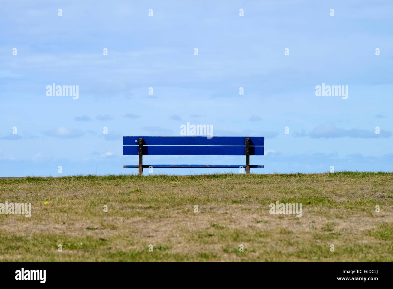 Empty blue wooden bench on seafront in Blackpool, Lancashire, England Stock Photo