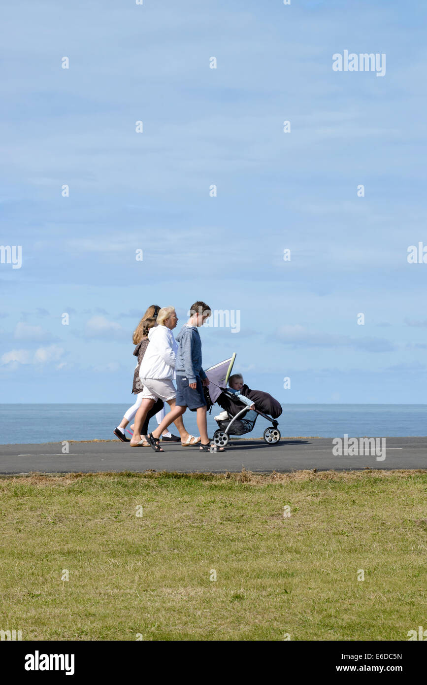 Family with young child in pushchair on coastal path in Blackpool, Lancashire Stock Photo